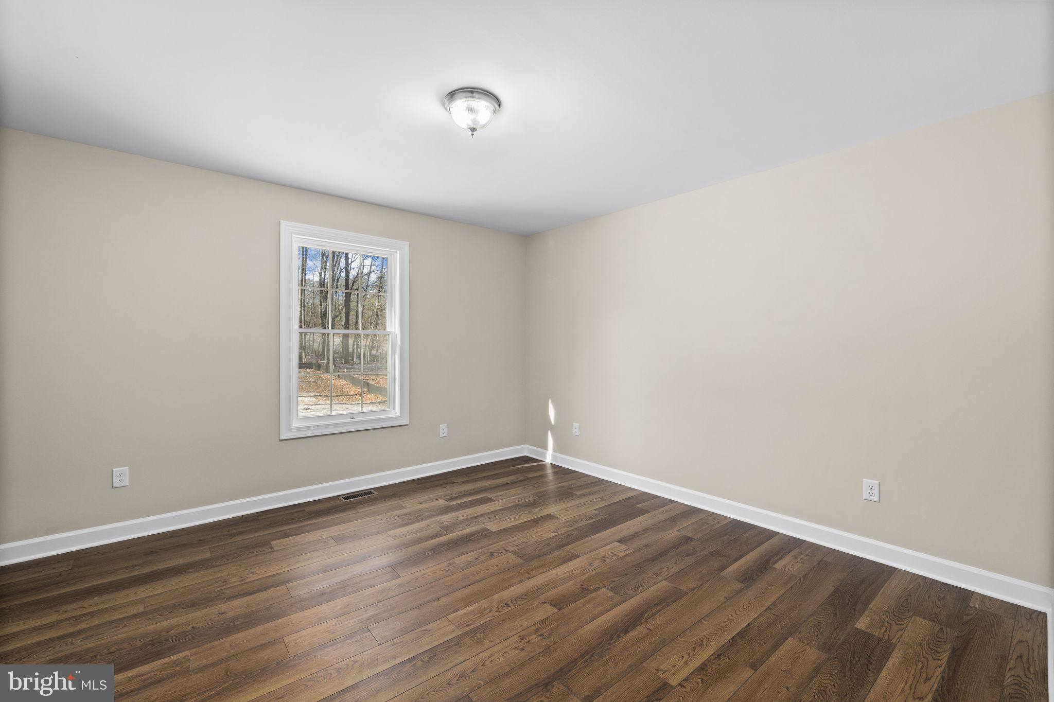 18078 Monrovia Road Orange, VA 22960 - Photo 15 of 49 an empty room with wooden floor and windows