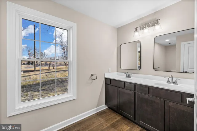 a bathroom with a double vanity sink and a mirror