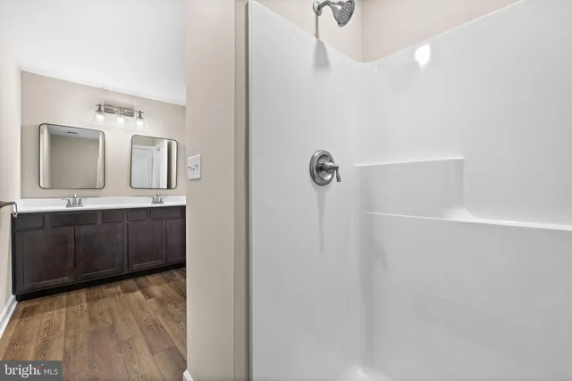 a bathroom with a sink a toilet and mirror