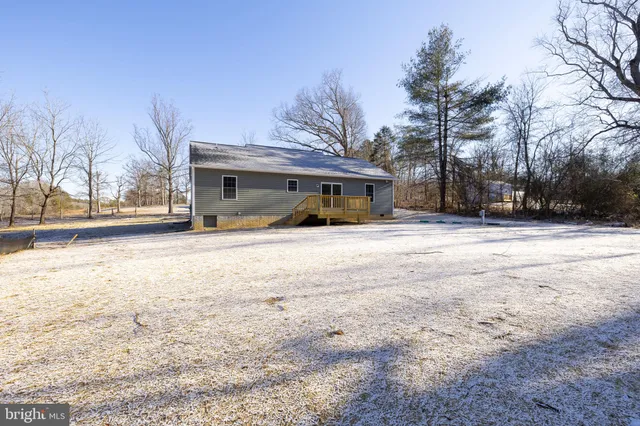 a view of a house with snow on the road