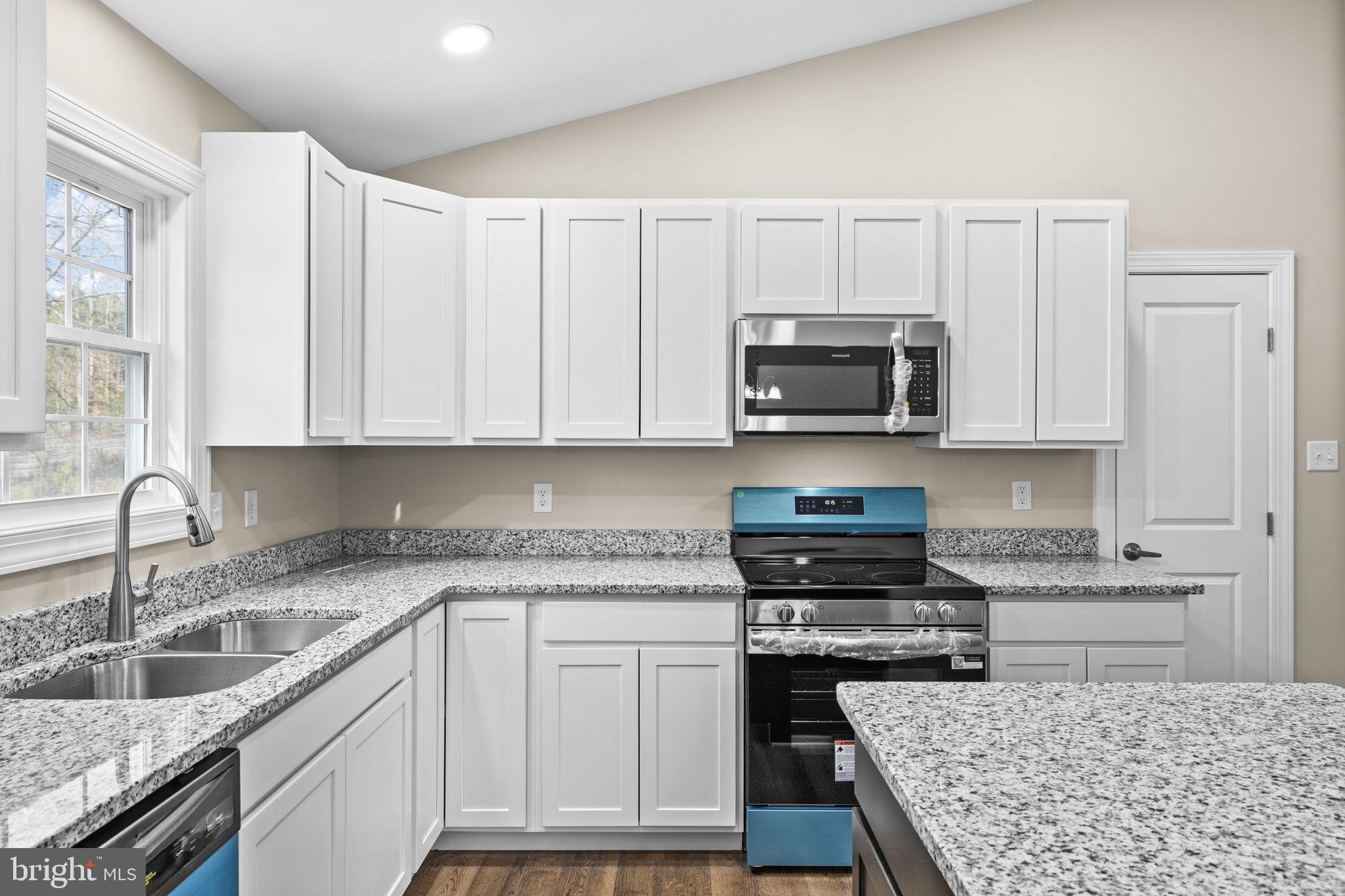 18078 Monrovia Road Orange, VA 22960 - Photo 38 of 49 a kitchen with granite countertop a stove sink and cabinets