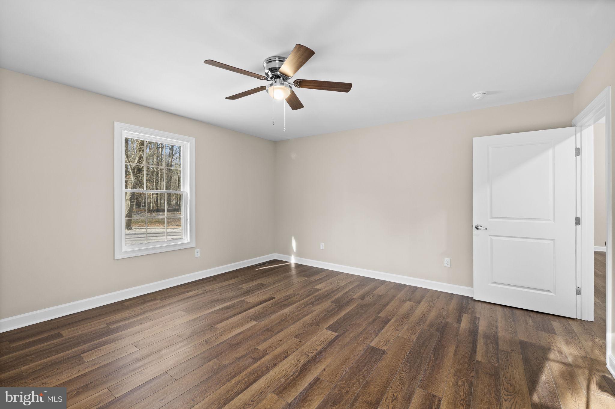 18078 Monrovia Road Orange, VA 22960 - Photo 42 of 49 a view of an empty room with wooden floor and a window