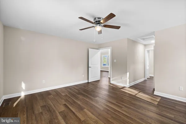 a view of an empty room and wooden floor