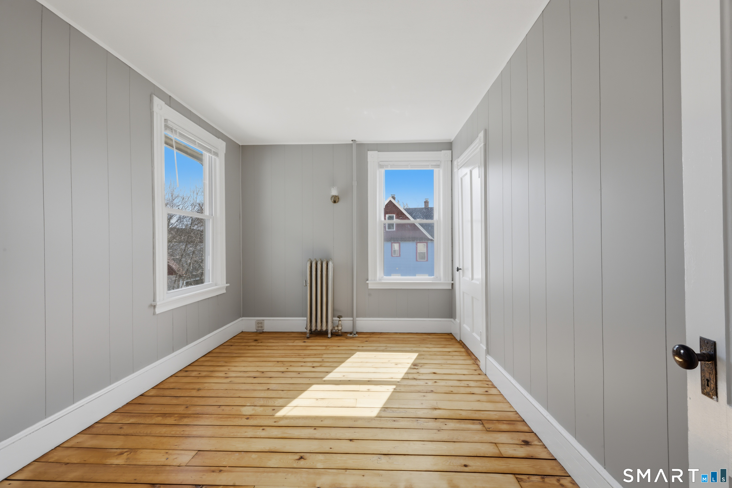 43 Dunham Street Norwich, CT 06360 - Photo 16 of 26 a view of a room with wooden floor and window