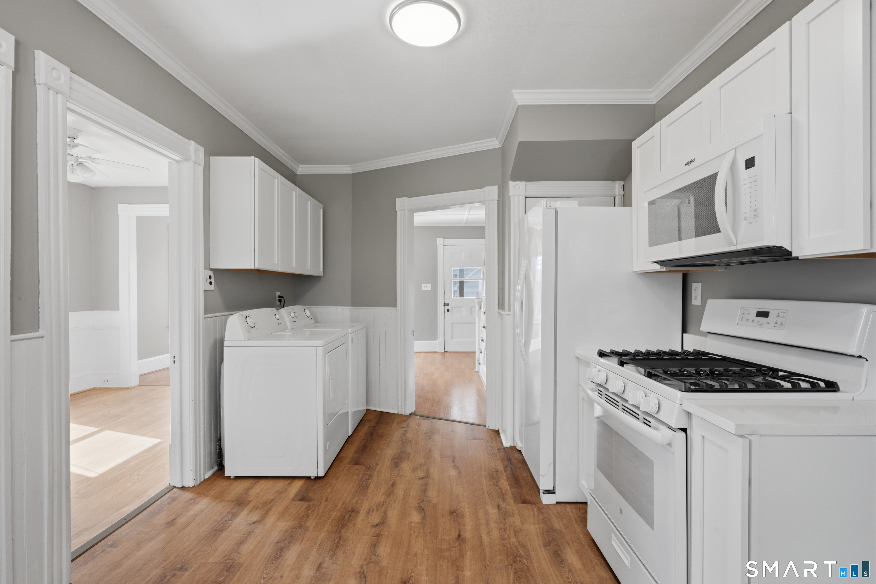 43 Dunham Street Norwich, CT 06360 - Photo 2 of 26 a kitchen with cabinets and wooden floor