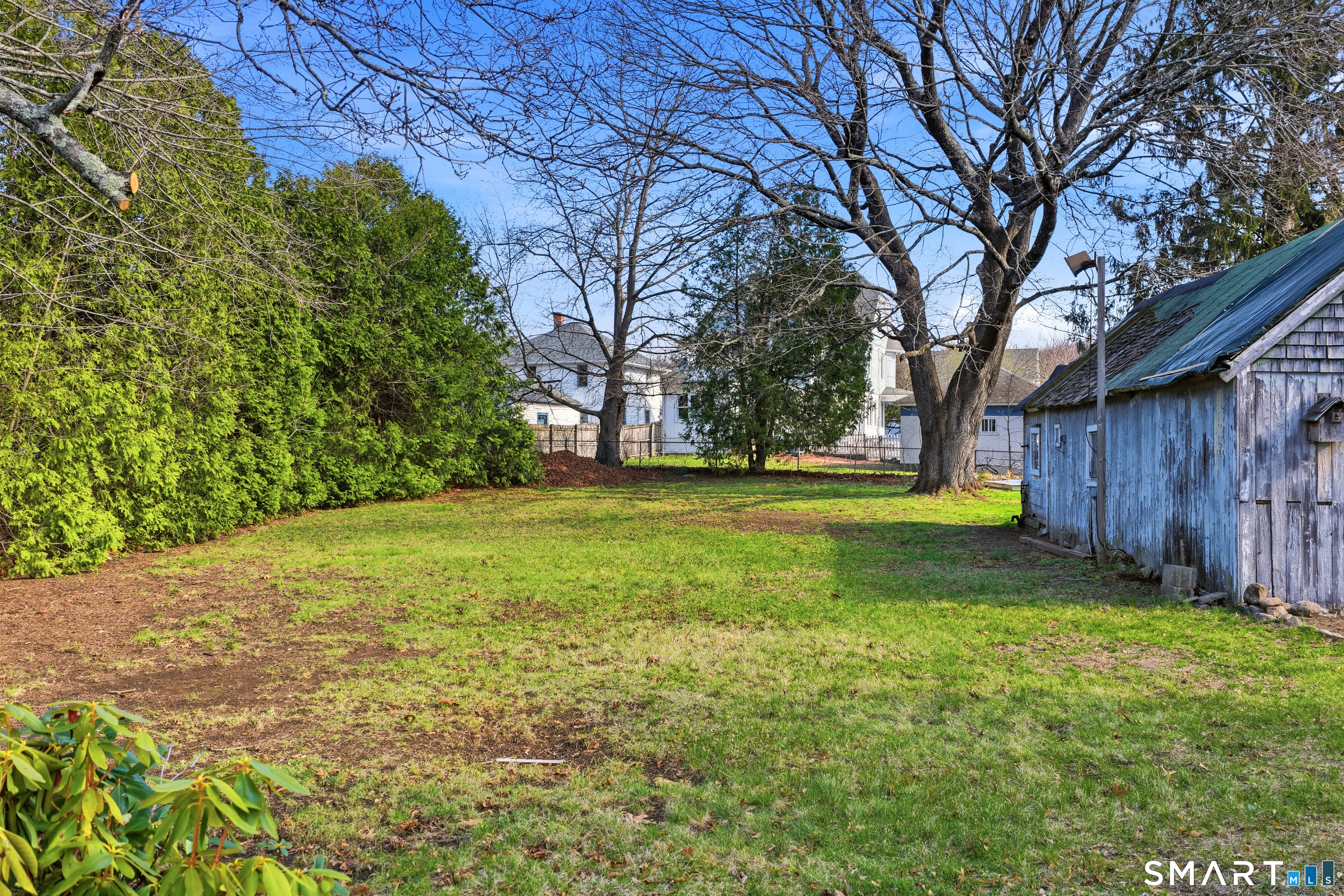 43 Dunham Street Norwich, CT 06360 - Photo 9 of 26 a view of a yard with large trees