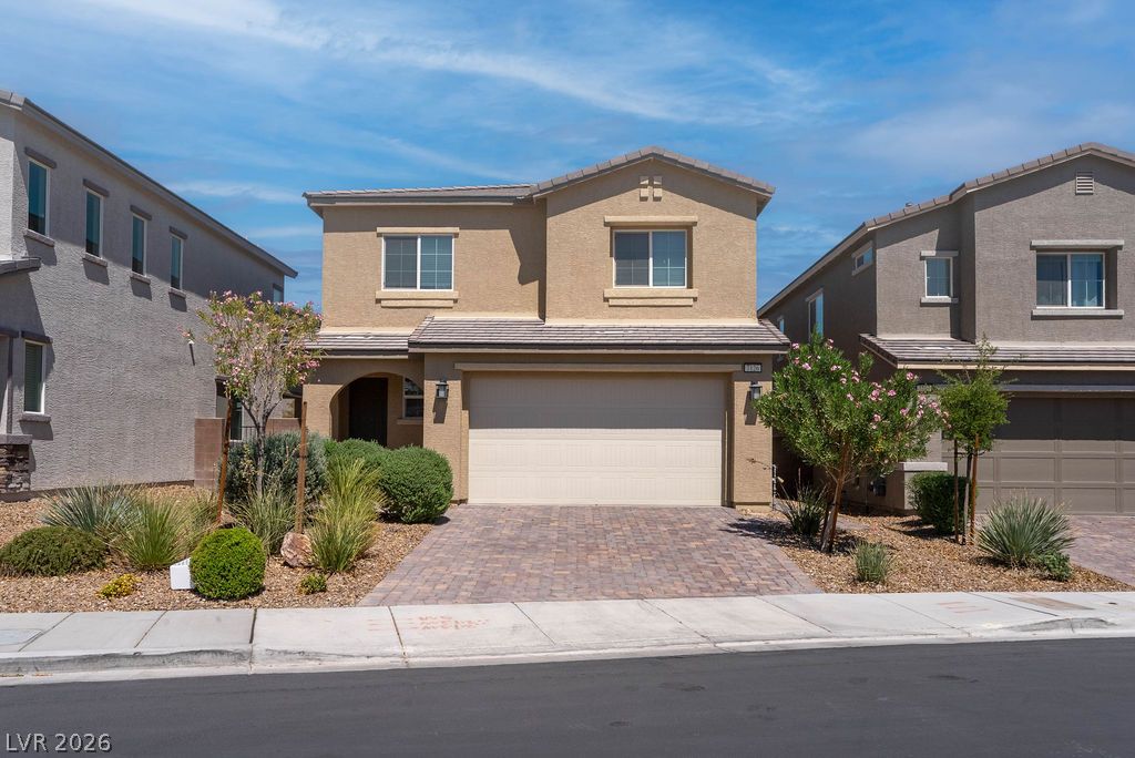 7126 Calvert Cliffs Street North Las Vegas, NV 89084 - Photo 1 of 44 A welcoming facade showcases a paver driveway, mature landscaping, and an integrated garage.