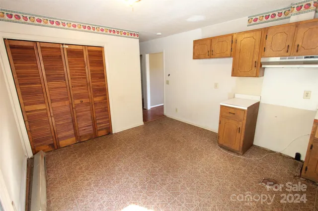 a view of a hallway with wooden floor and entryway