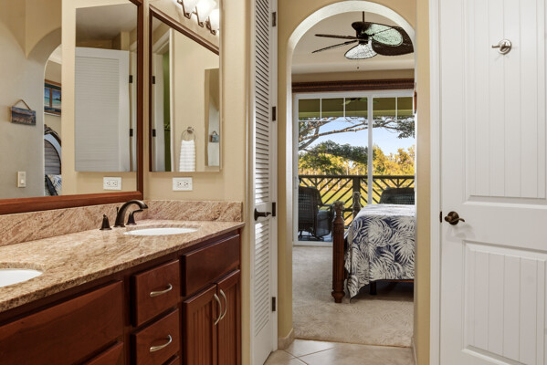 69-180 Waikoloa Beach Drive, Unit O1 Waikoloa, HI 96738 - Photo 17 of 29 a en suite bathroom with a granite countertop sink and a mirror