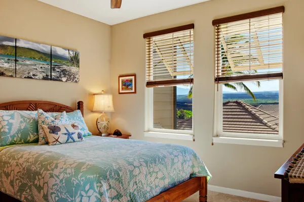 a bedroom with a bed and a wall painting