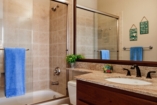 69-180 Waikoloa Beach Drive, Unit O1 Waikoloa, HI 96738 - Photo 23 of 29 a bathroom with a granite countertop sink a mirror and shower