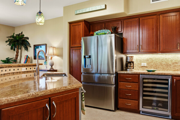 69-180 Waikoloa Beach Drive, Unit O1 Waikoloa, HI 96738 - Photo 5 of 29 a kitchen with kitchen island a counter space a sink appliances and cabinets