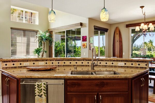 a view of a dining room and livingroom with furniture wooden floor a chandelier