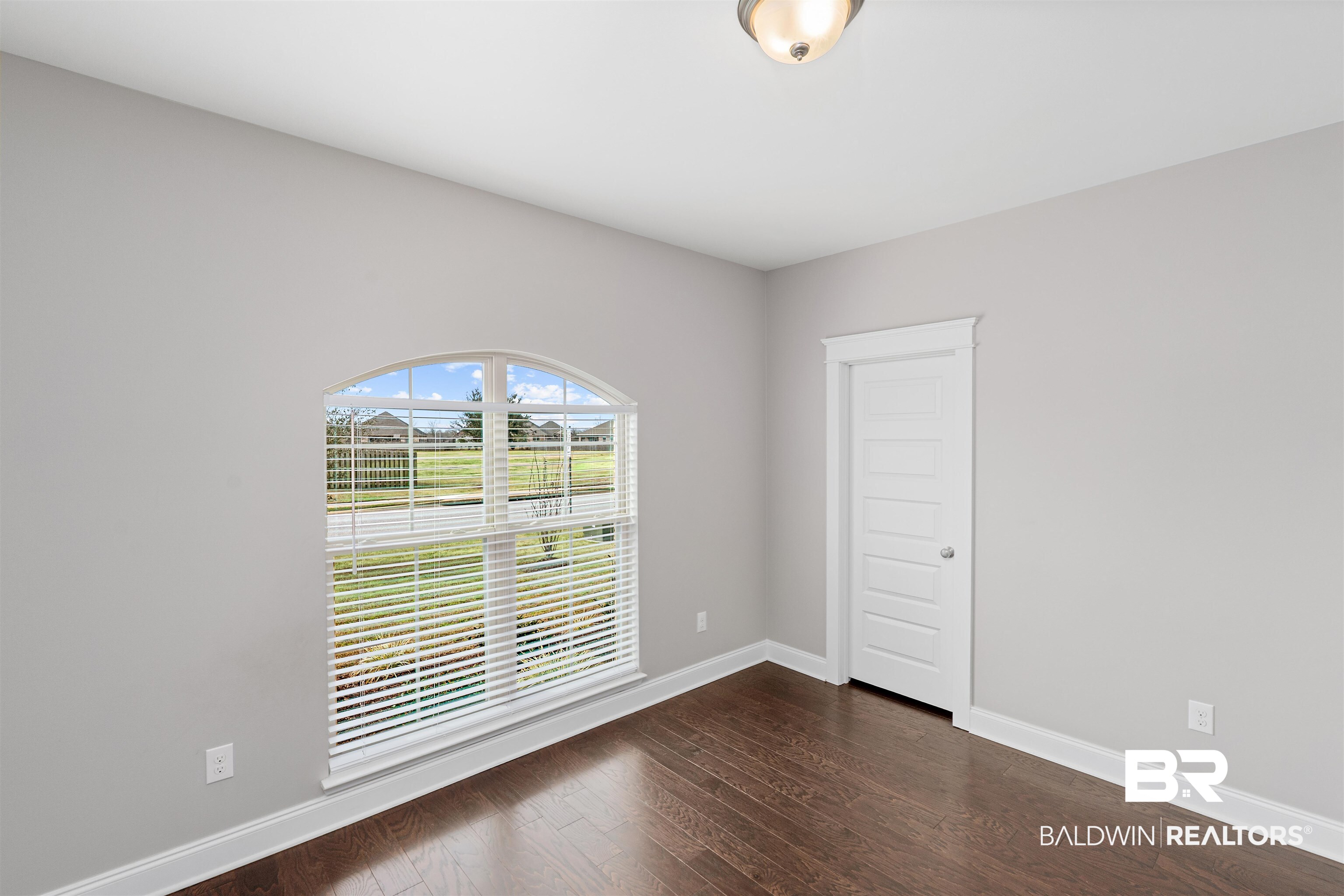 24838 Slater Mill Road Daphne, AL 36526 - Photo 21 of 46 Unfurnished room featuring dark wood-type flooring and baseboards