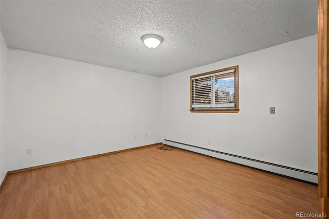 a view of a room with wooden floor and window