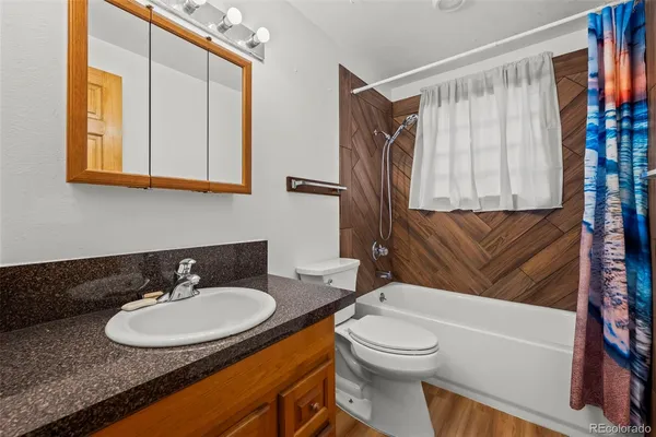 a bathroom with a sink a toilet and a bathtub