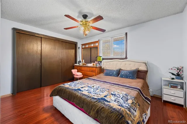a bedroom with a large bed and a chandelier