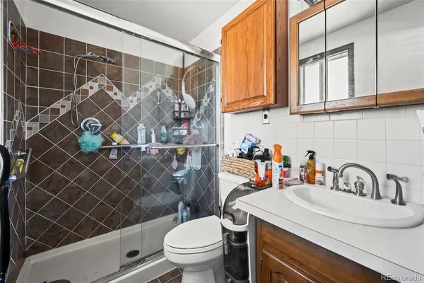 a bathroom with a sink toilet and shower
