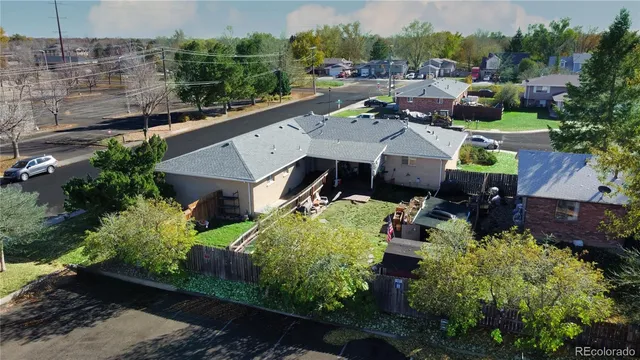 an aerial view of multiple houses with yard