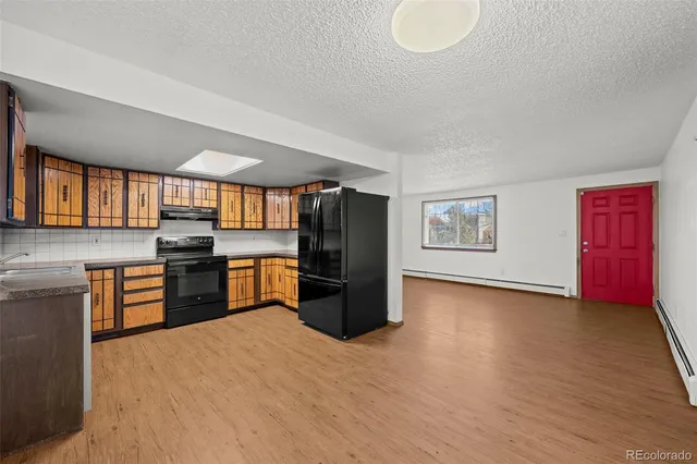 a kitchen with stainless steel appliances granite countertop a refrigerator and stove top oven