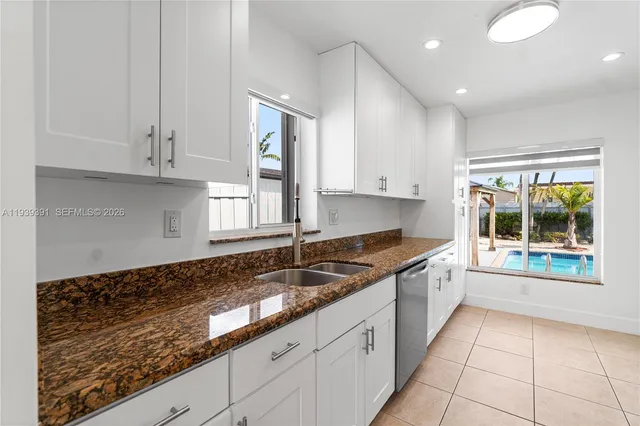 a kitchen with granite countertop a sink and a stove