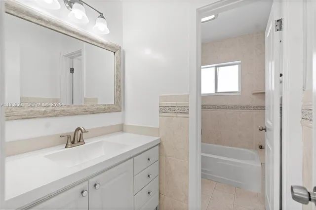 a bathroom with a sink a vanity and a mirror