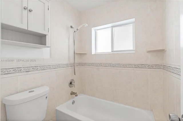 a bathroom with a bathtub and a window