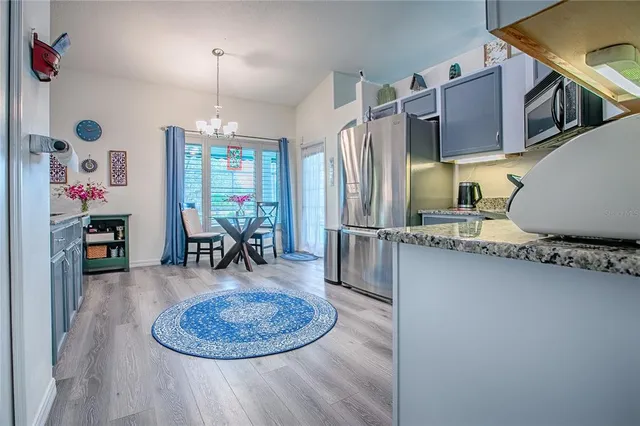 a kitchen with stainless steel appliances granite countertop a refrigerator stove and sink