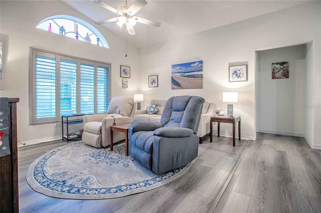 4802 Summerbridge Circle Leesburg, FL 34748 - Photo 16 of 67 a living room with furniture and a wooden floor