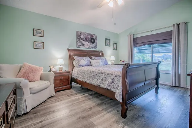 a large bed sitting in a bedroom next to a window
