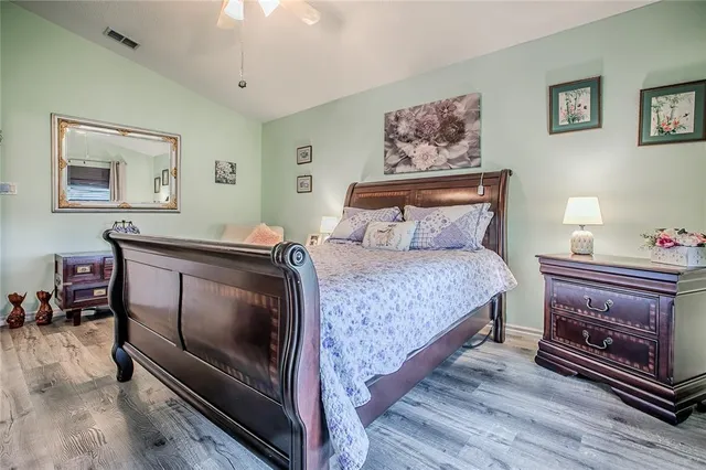 a bedroom with a bed and a dresser in it