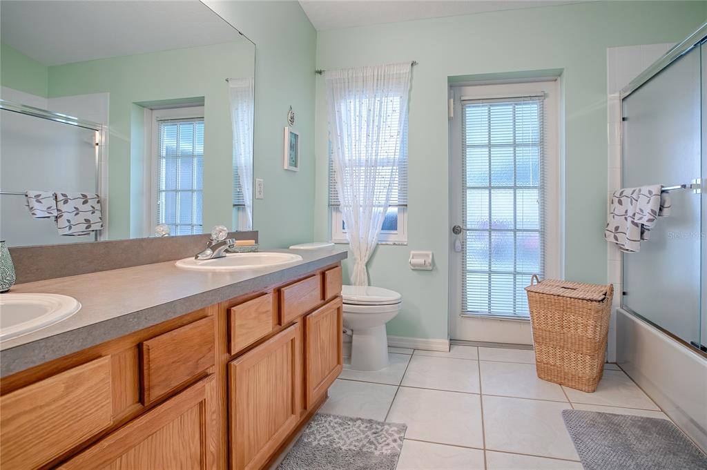 4802 Summerbridge Circle Leesburg, FL 34748 - Photo 26 of 67 a spacious bathroom with a granite countertop sink toilet and shower