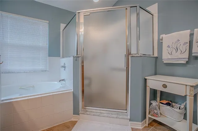 a front view of a house with a big yard and potted plants