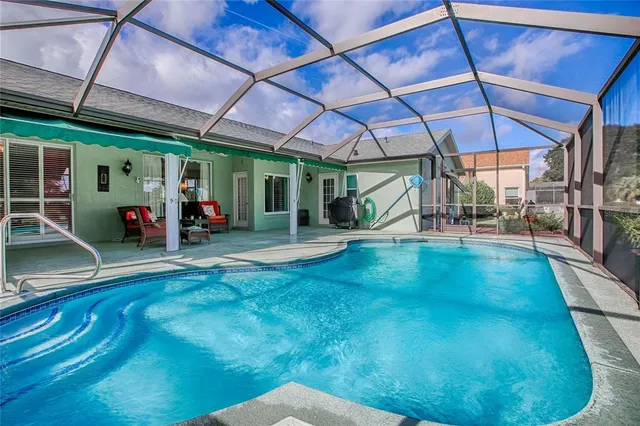 an aerial view of a house with outdoor space pool and a large yard