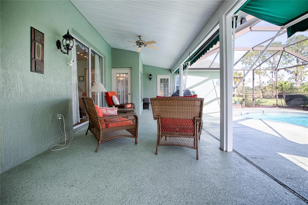 4802 Summerbridge Circle Leesburg, FL 34748 - Photo 42 of 67 a living room with furniture a fireplace and a floor to ceiling window