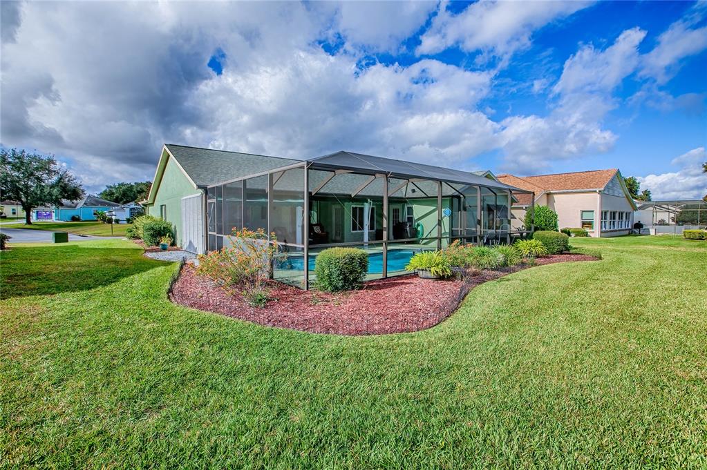 4802 Summerbridge Circle Leesburg, FL 34748 - Photo 44 of 67 a front view of a house with a big yard and potted plants