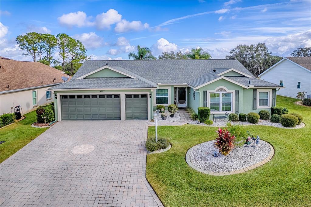 4802 Summerbridge Circle Leesburg, FL 34748 - Photo 48 of 67 a front view of a house with a yard and garage