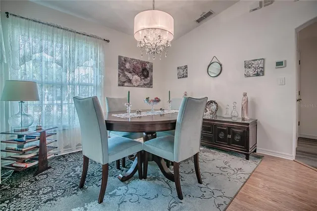 a kitchen with stainless steel appliances granite countertop a refrigerator a stove and a wooden floors