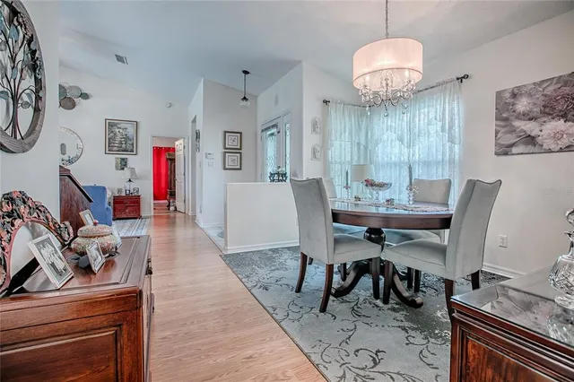 a view of a dining room with furniture and chandelier