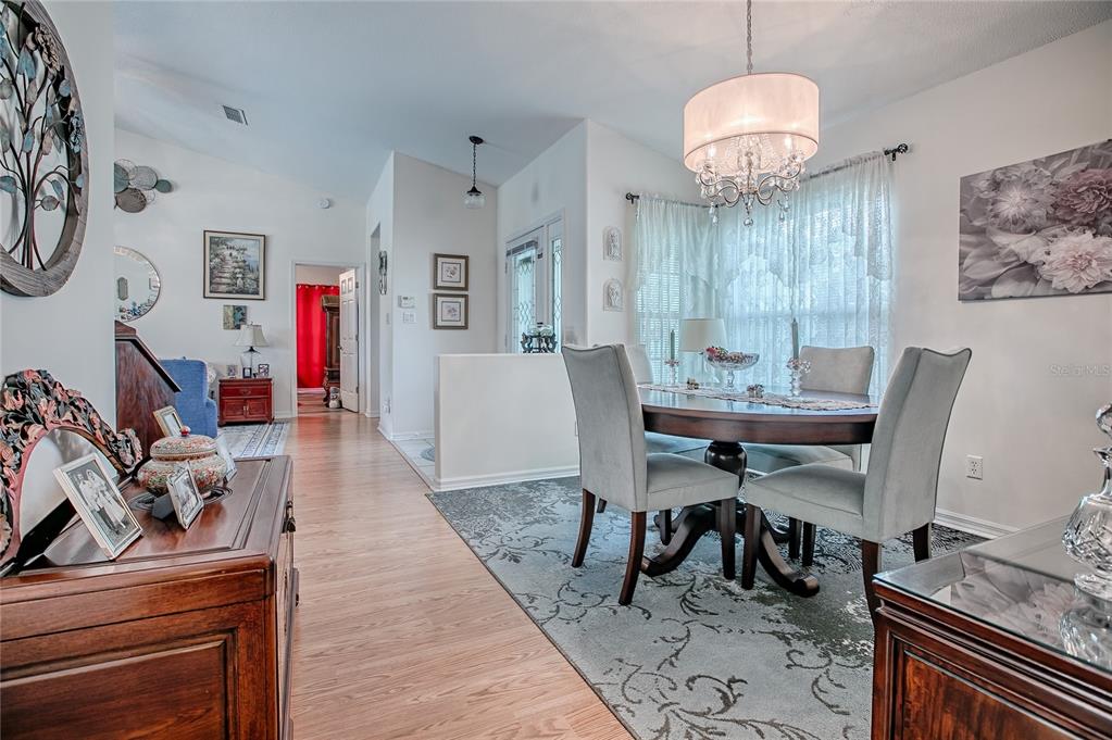 4802 Summerbridge Circle Leesburg, FL 34748 - Photo 10 of 67 a view of a dining room with furniture window and wooden floor