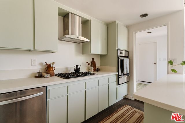 a kitchen with stainless steel appliances granite countertop a sink and cabinets