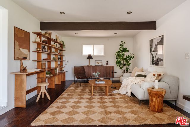 a living room with furniture lamp and rug