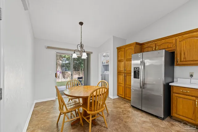 a dining room with furniture a chandelier and window