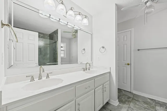 a bathroom with a sink double vanity granite tub and shower