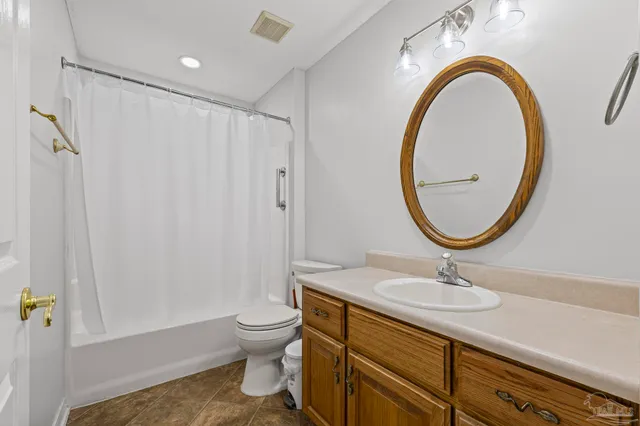 a bathroom with a sink a mirror a toilet and a shower