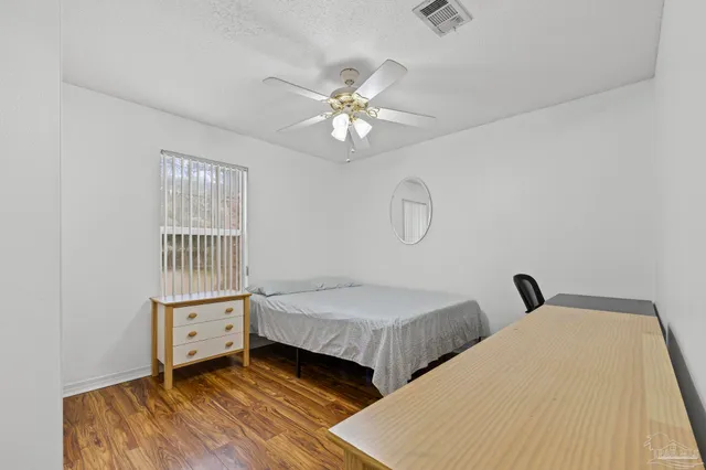 a bedroom with two beds and a chandelier