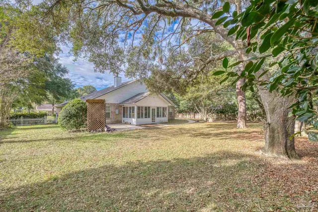 a front view of a house with yard and green space
