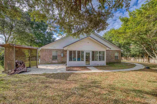 a front view of a house with a yard and pathway