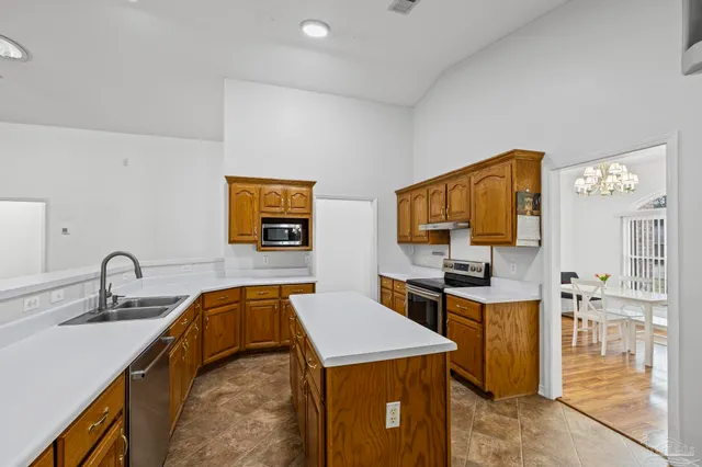 a kitchen with a stove a sink and a refrigerator
