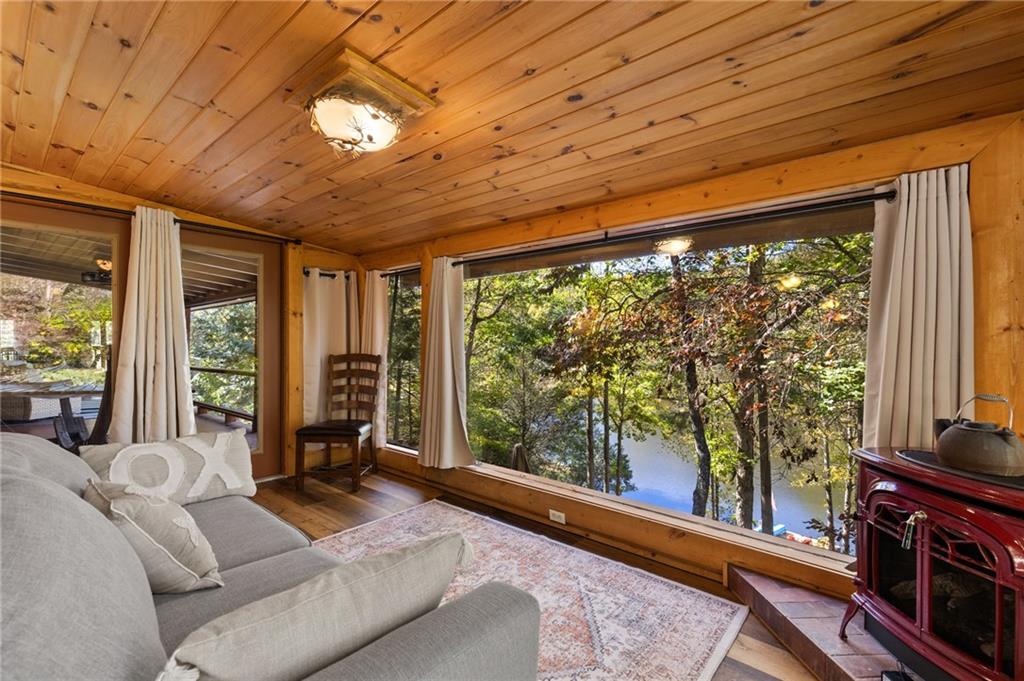 454 High Country Lane Morganton, GA 30560 - Photo 38 of 79 a living room with furniture a flat screen tv and a floor to ceiling window